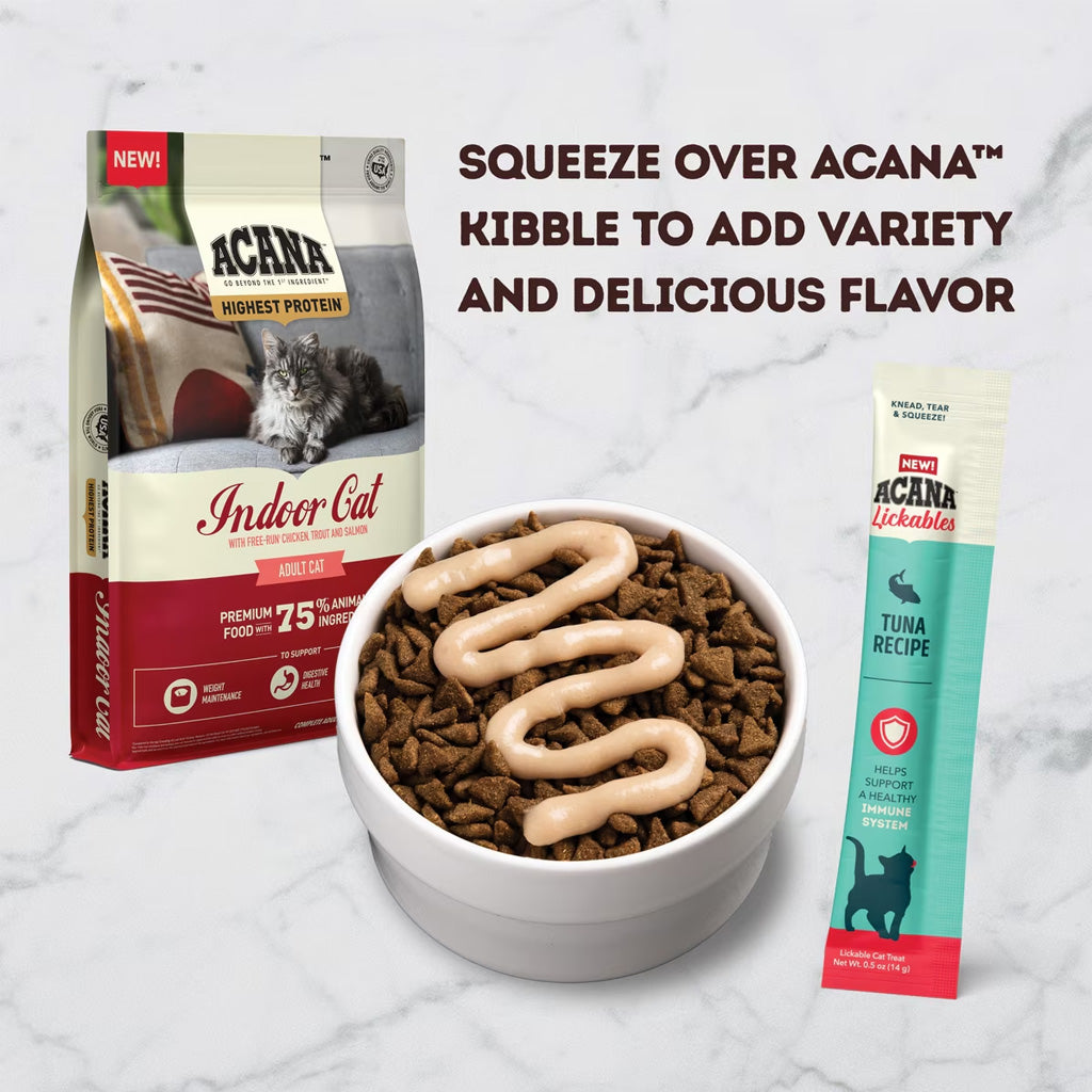 Acana cat food package, bowl with food, and Acana lickables on a marble background