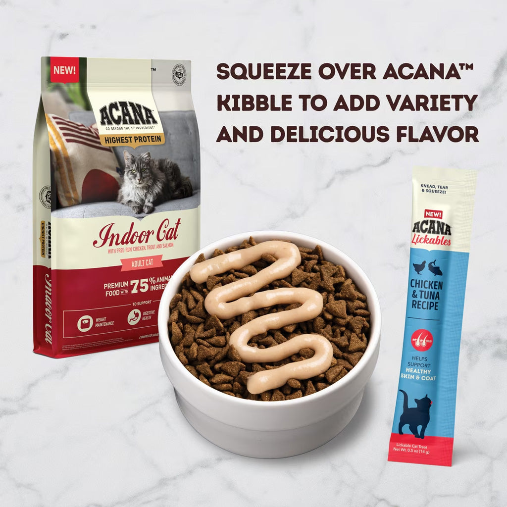 Acana cat food packaging with a bowl of cat food and a squeeze pack on a marble surface.