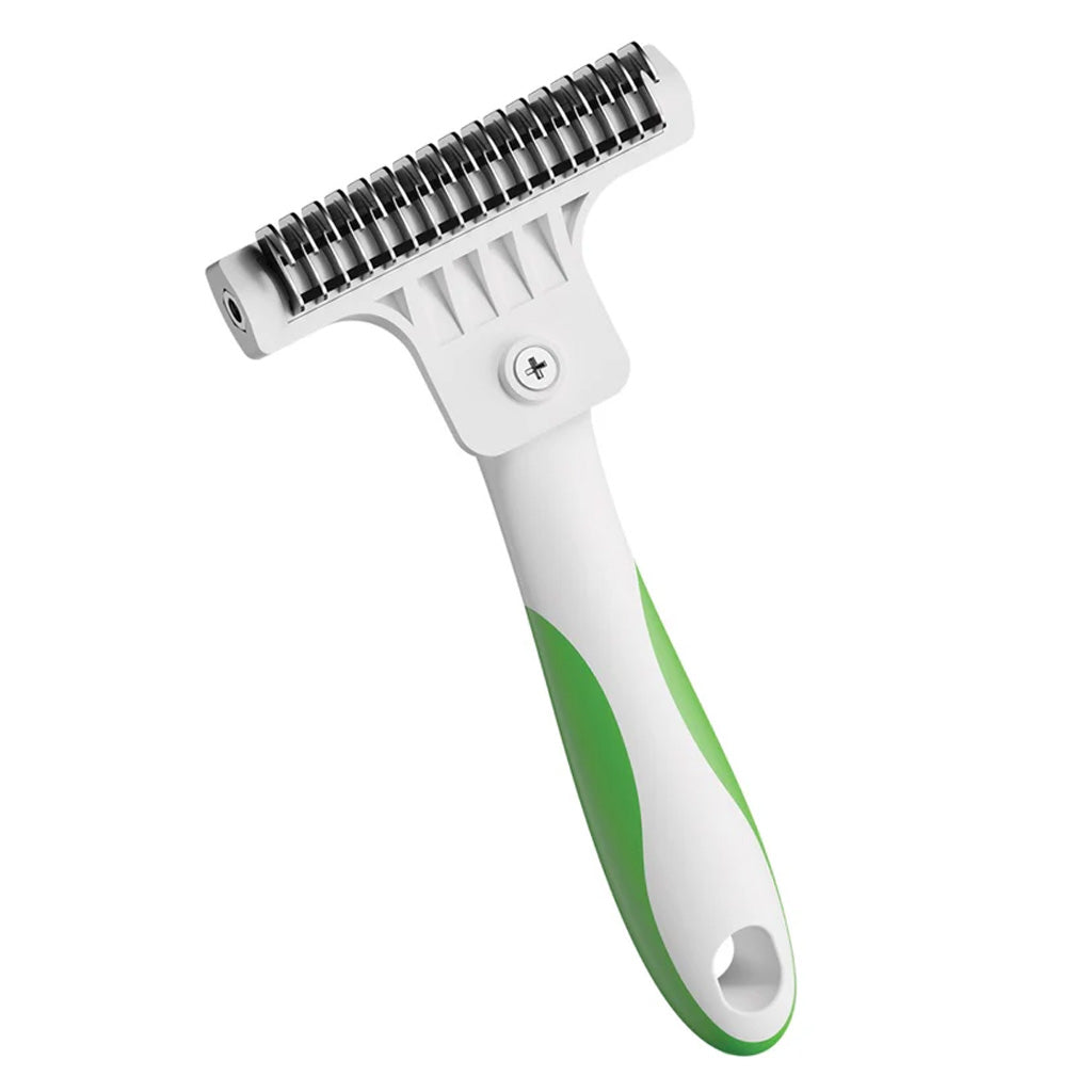 Pet grooming brush with green handle on a white background