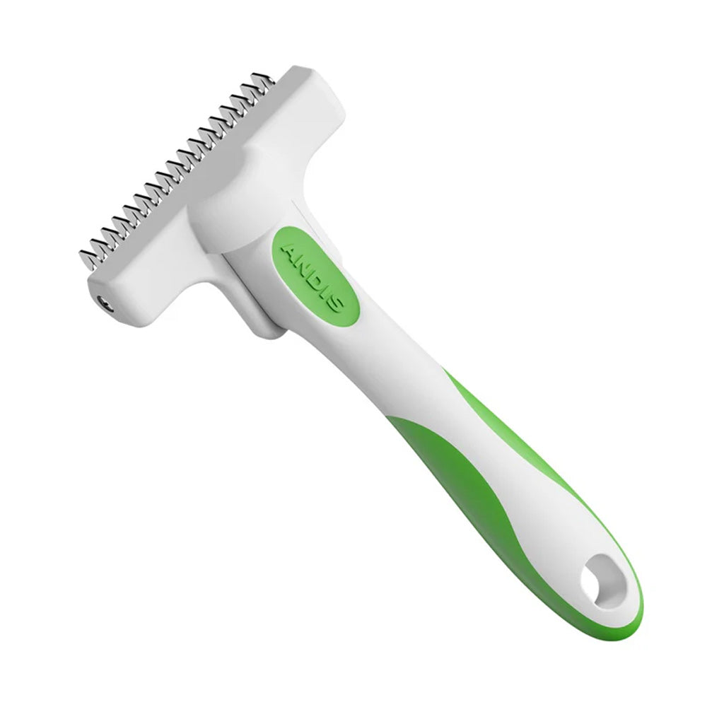 Pet grooming brush with green handle and white bristles on a white background
