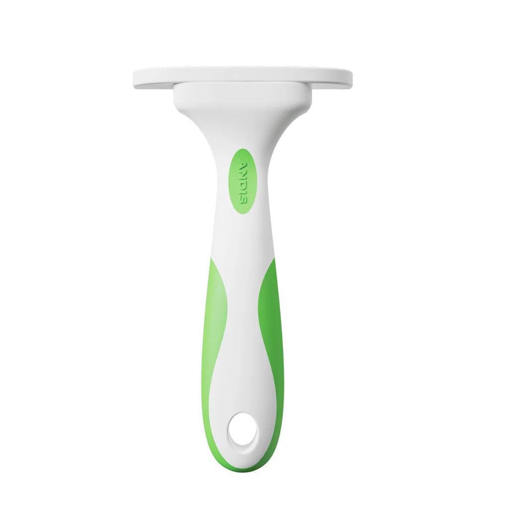 Green and white pet grooming tool on a white background