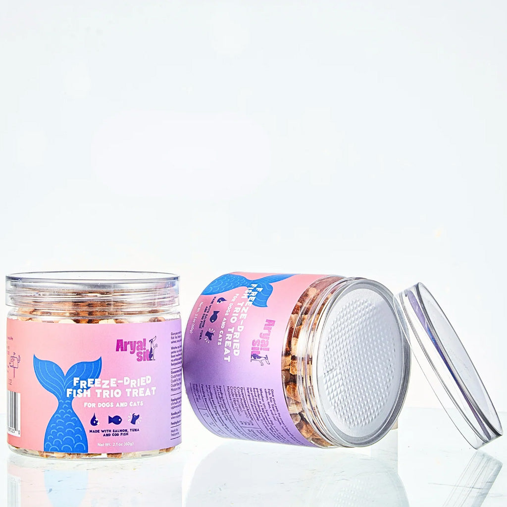 Two jars of Arvala Silke fish trio treats with pink labels on a white background