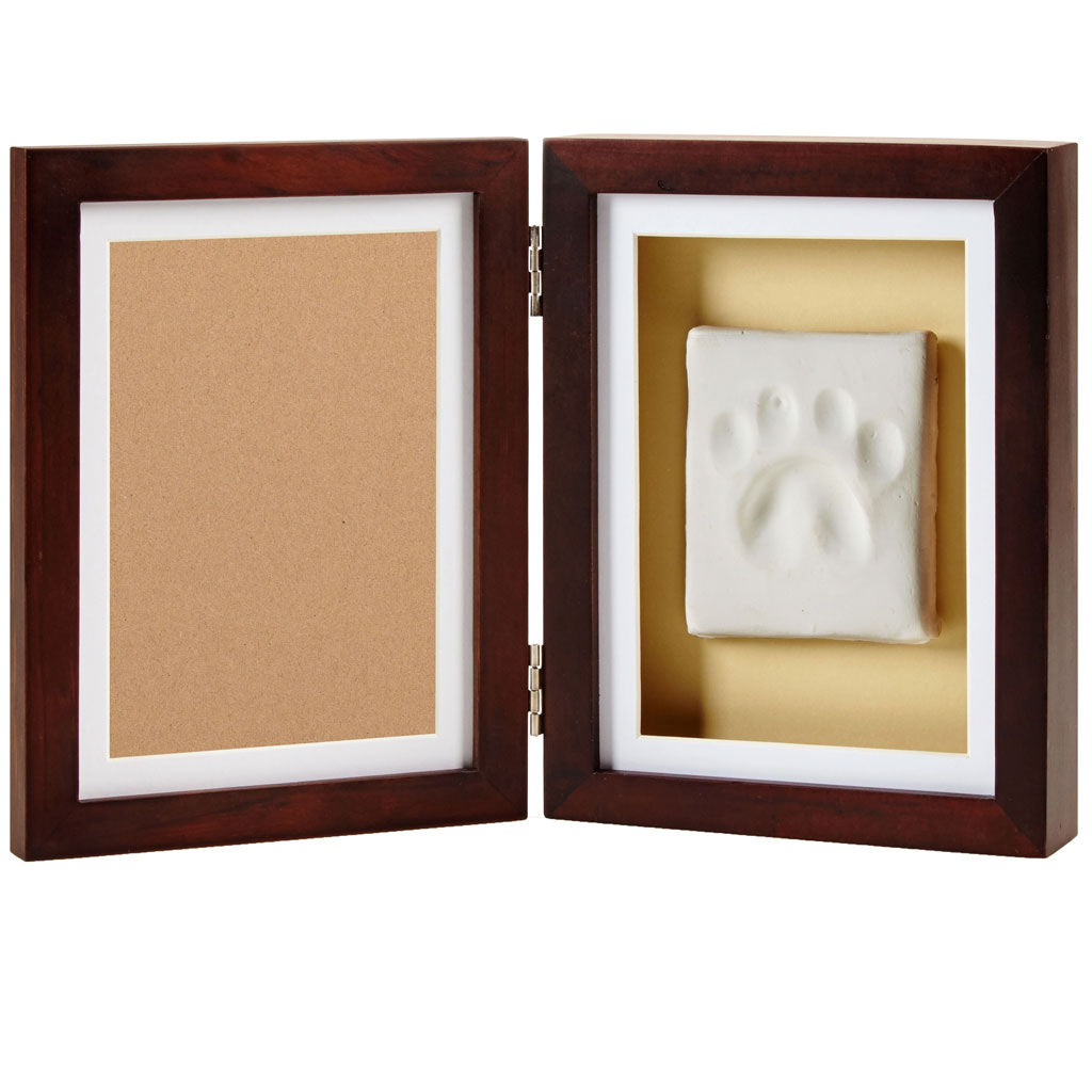 Wooden frame with a white paw print inside on a beige background