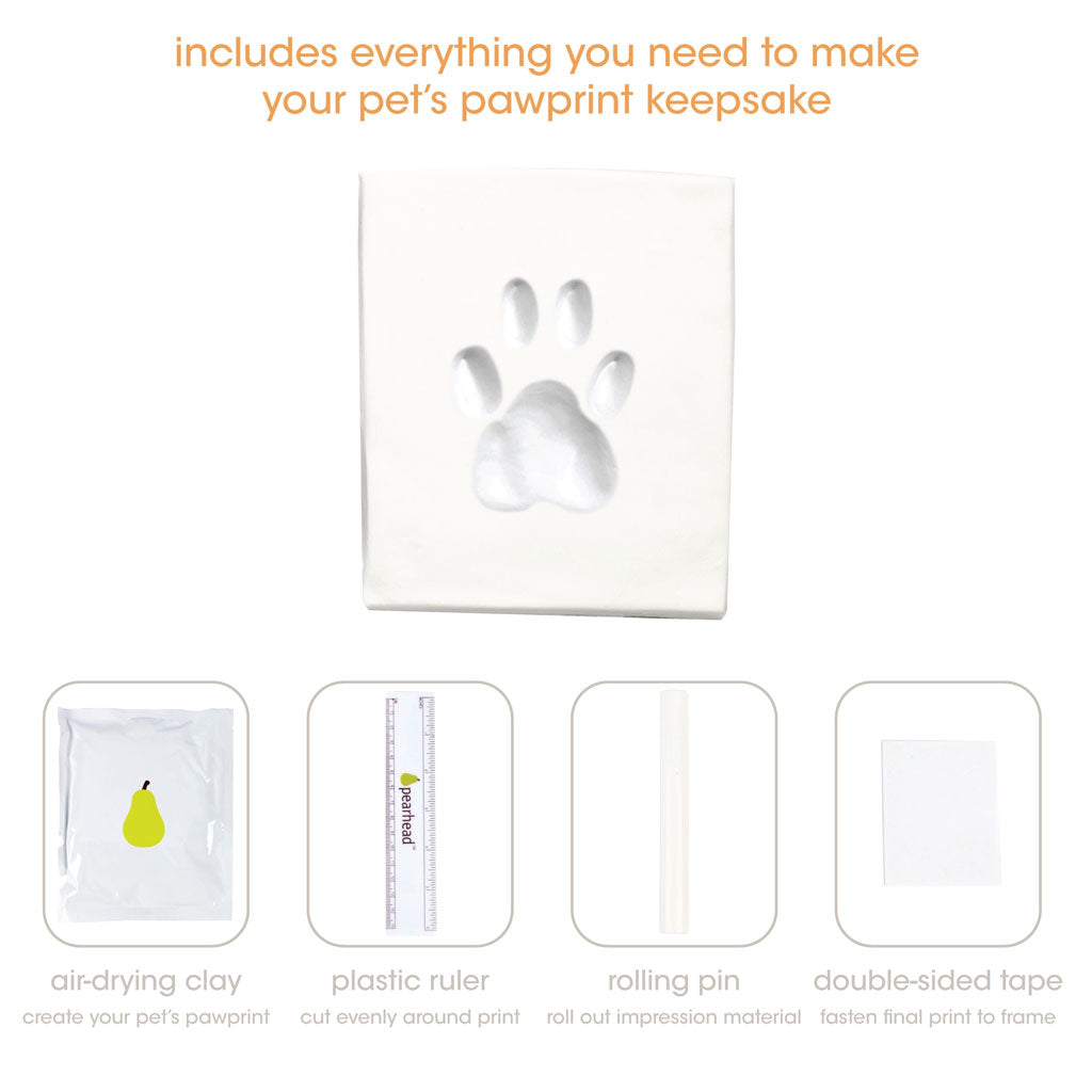 Pet pawprint keepsake kit with air-drying clay, plastic ruler, rolling pin, and double-sided tape on a white background.