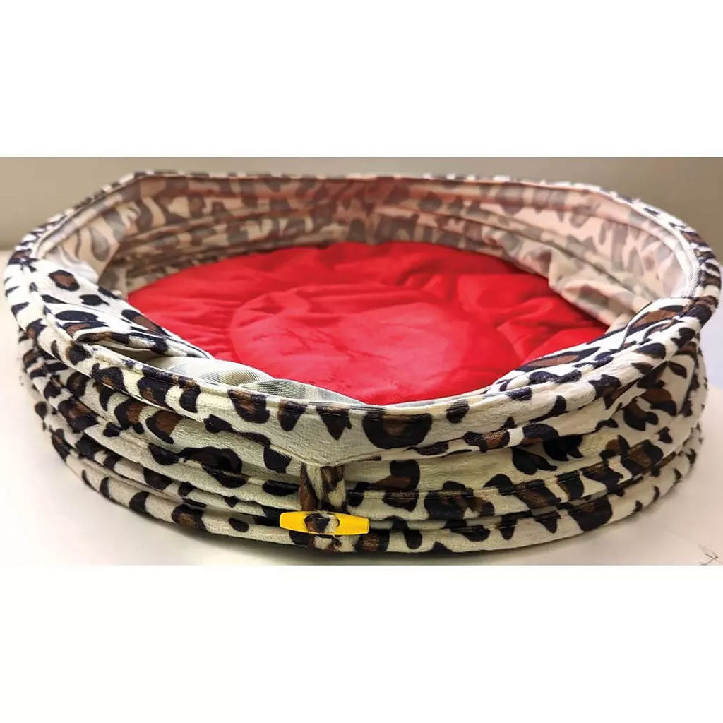 Pet bed with leopard print exterior and red interior on a white background